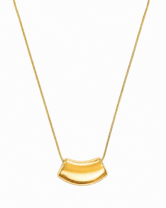 A gold necklace featuring a curved, semi-circular pendant on a delicate gold chain, presented against a plain white background.