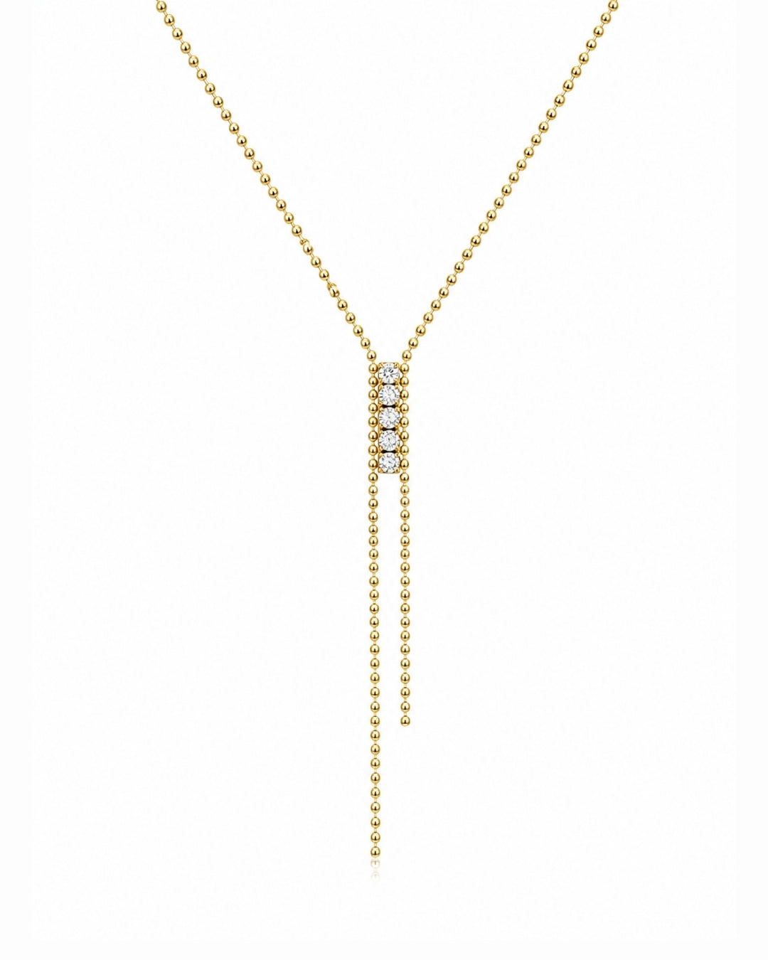 A delicate gold Y-necklace featuring a central cluster of small clear stones and two long dangling bead chains, shown on a plain white background.