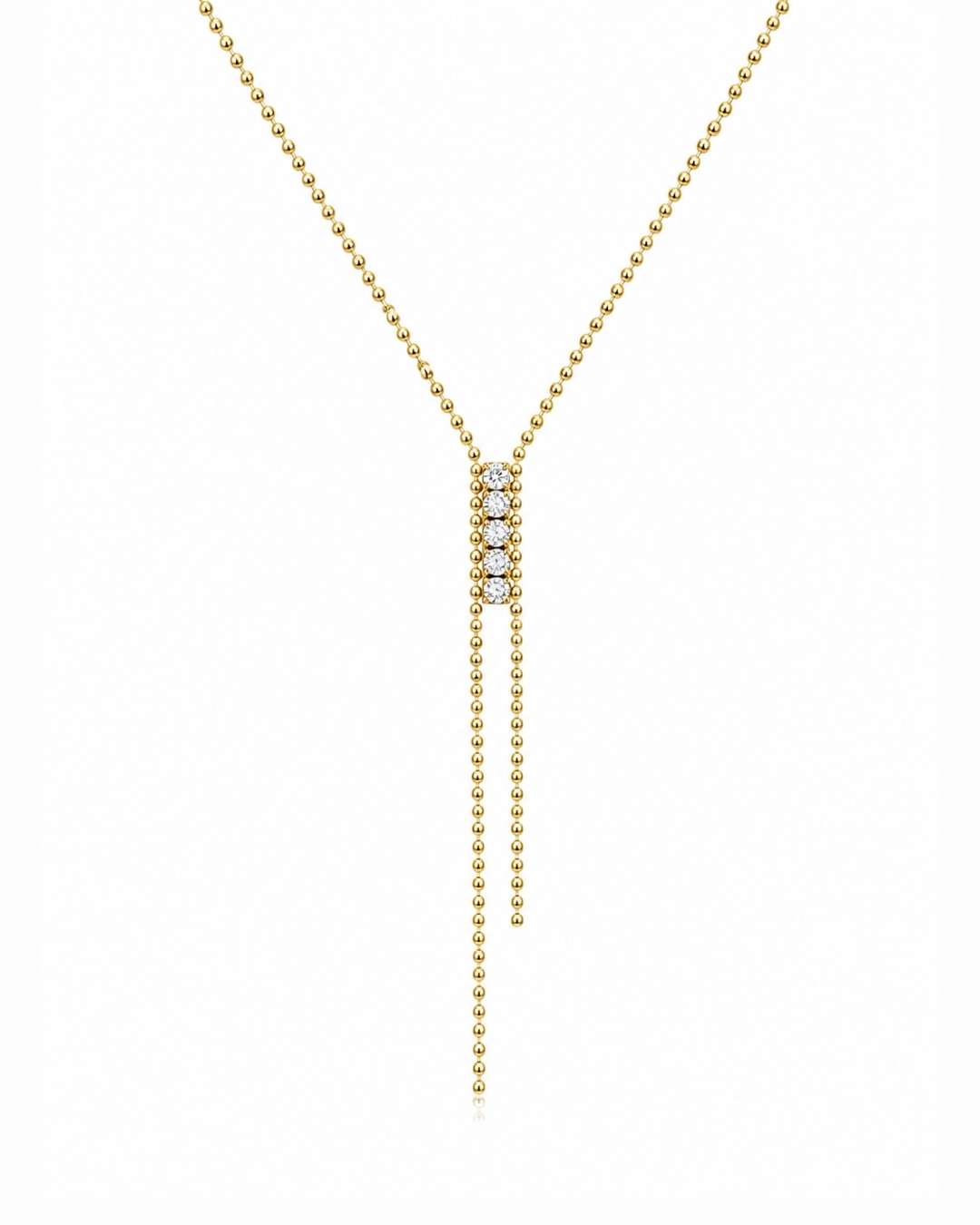 A delicate gold Y-necklace featuring a central cluster of small clear stones and two long dangling bead chains, shown on a plain white background.