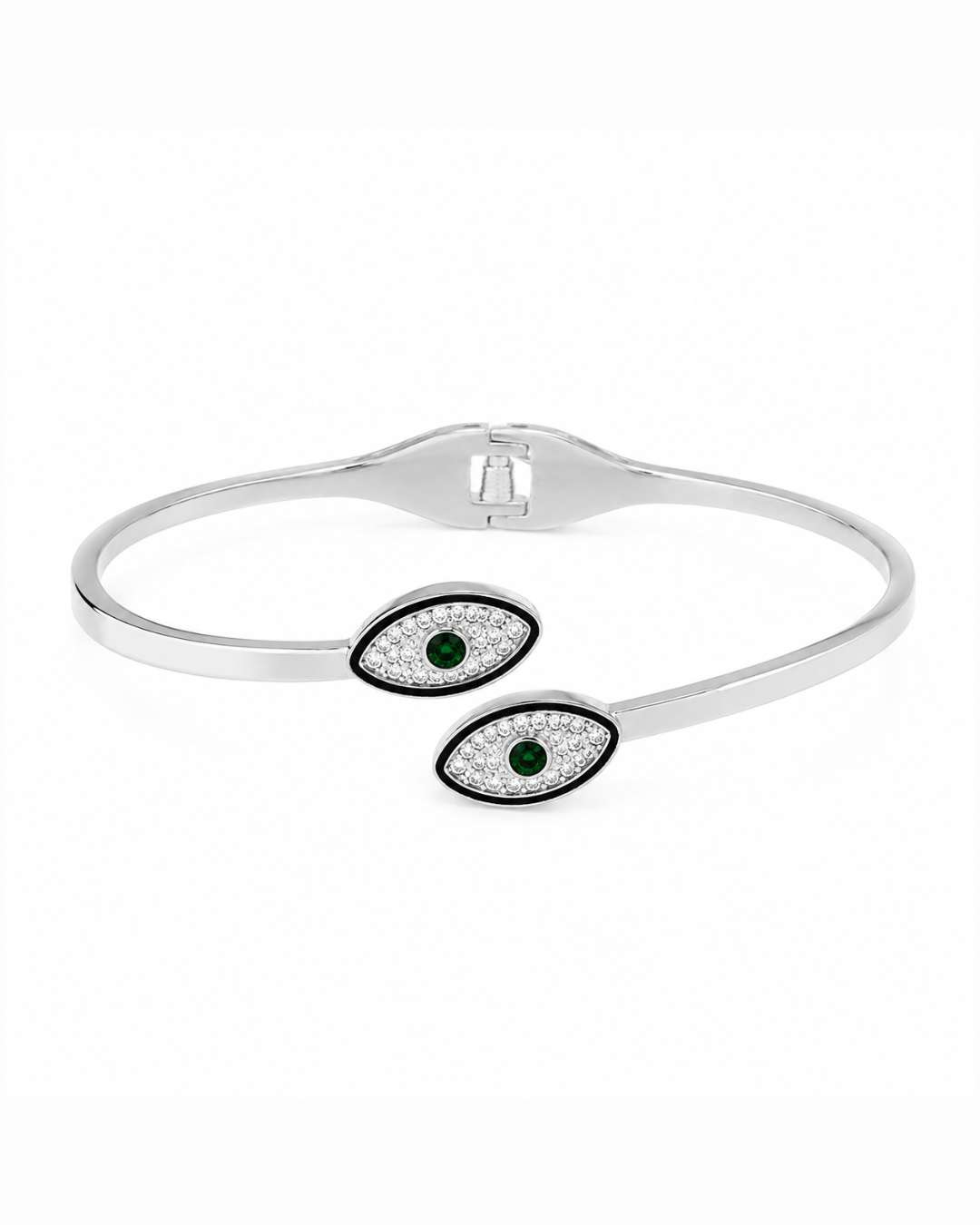 A silver-toned open cuff bangle bracelet featuring two evil eye charms with black borders, clear pavé stones, and green gemstone centers, shown on a plain white background.