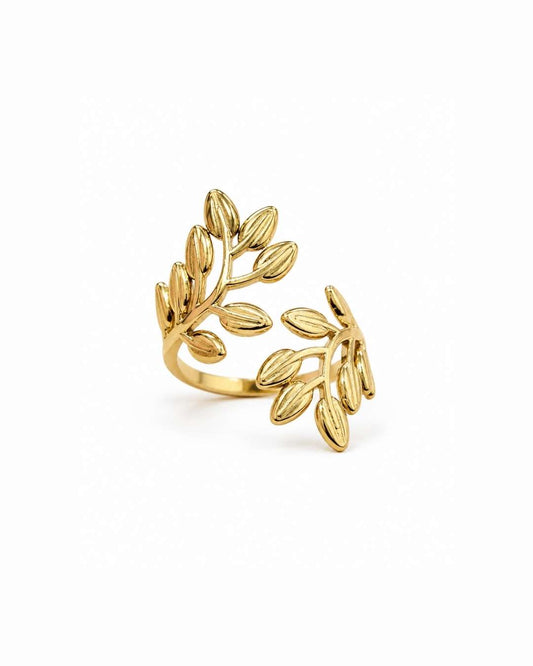 A gold leaf branch wrap ring on a clean white background.