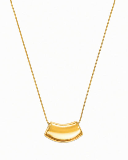 A gold necklace featuring a curved, semi-circular pendant on a delicate gold chain, presented against a plain white background.