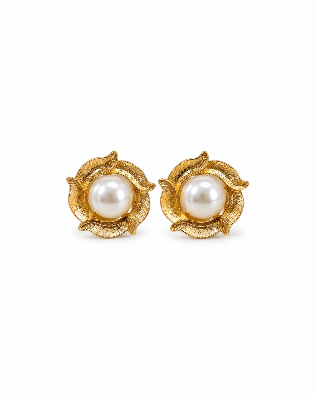 A pair of gold flower-shaped stud earrings with a central white pearl, set against a plain white background.