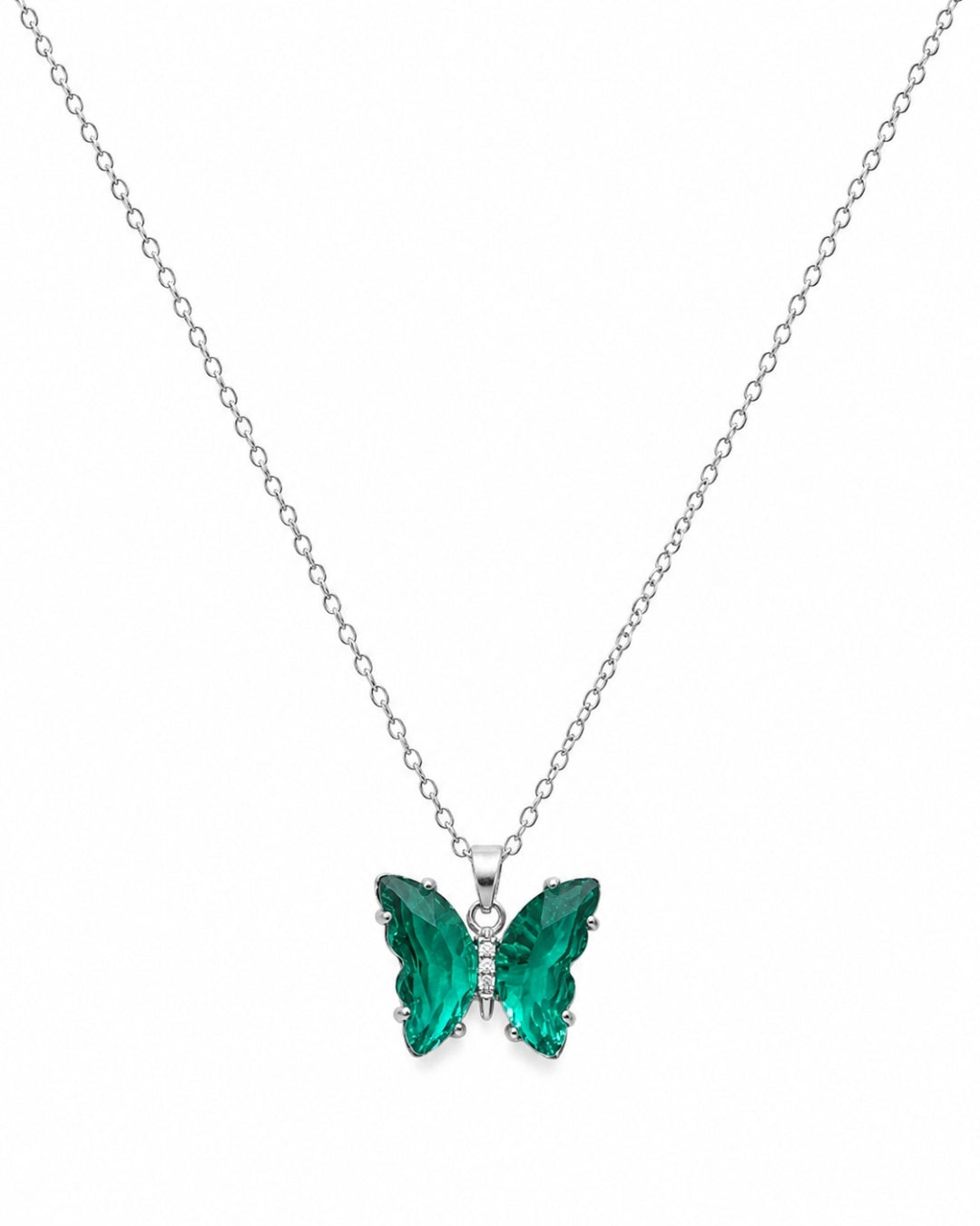 A silver chain necklace with a butterfly pendant featuring vibrant green faceted crystal wings, set against a plain white background.
