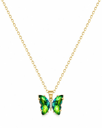 A gold chain necklace with a butterfly-shaped pendant featuring green and blue iridescent gemstones, set against a plain white background.