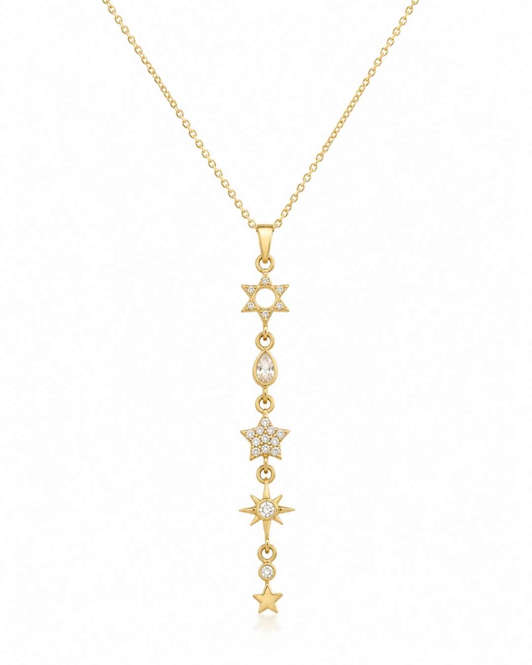 A gold lariat-style pendant necklace featuring a vertical line of star and moon motifs, some adorned with small clear stones, shown on a plain white background.