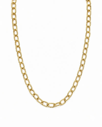 A gold chain necklace with textured, elongated oval links, displayed against a solid white background.