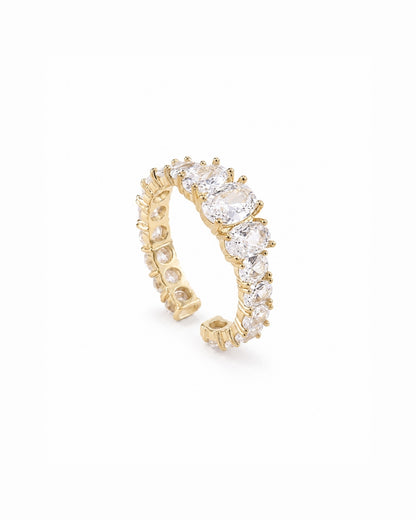 A gold band ring featuring a row of clear oval-cut stones, photographed on a clean white background.