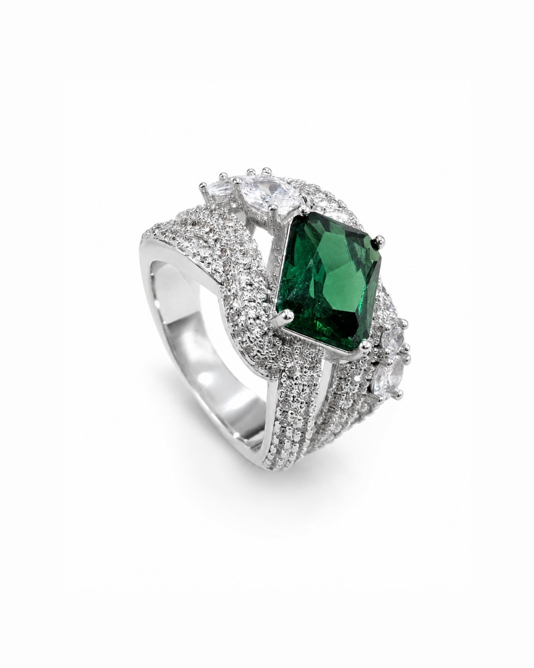 A silver-tone ring featuring a prominent rectangular green gemstone surrounded by pavé-set clear stones, photographed on a clean white background.