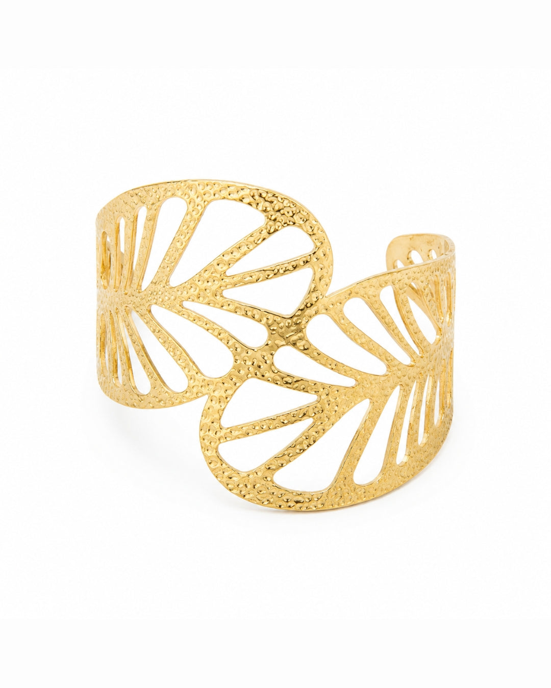 A textured gold cuff bracelet with a leaf-like openwork design, photographed on a clean white background.