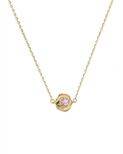 A delicate gold chain necklace featuring a small rose-shaped pendant with a light purple center and tiny green leaf accents, shown against a plain white background.