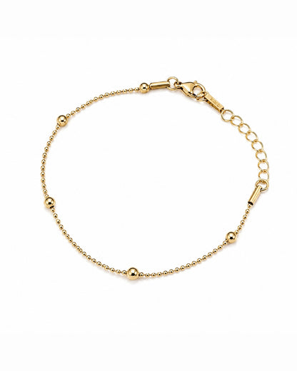 A delicate gold chain bracelet with small polished bead accents and a lobster clasp, displayed on a clean white background.