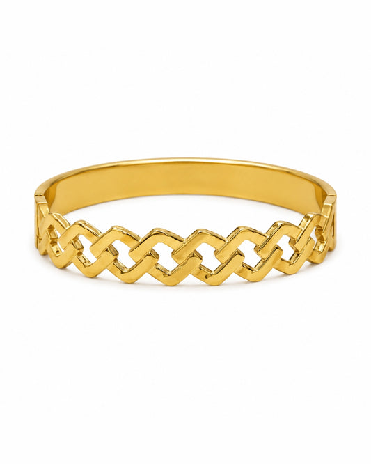 A polished gold bangle bracelet featuring a continuous interlocking geometric link pattern, shown on a clean white background.