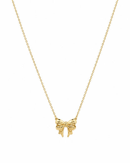 A delicate gold chain necklace featuring a small bow-shaped pendant, presented on a clean white background.
