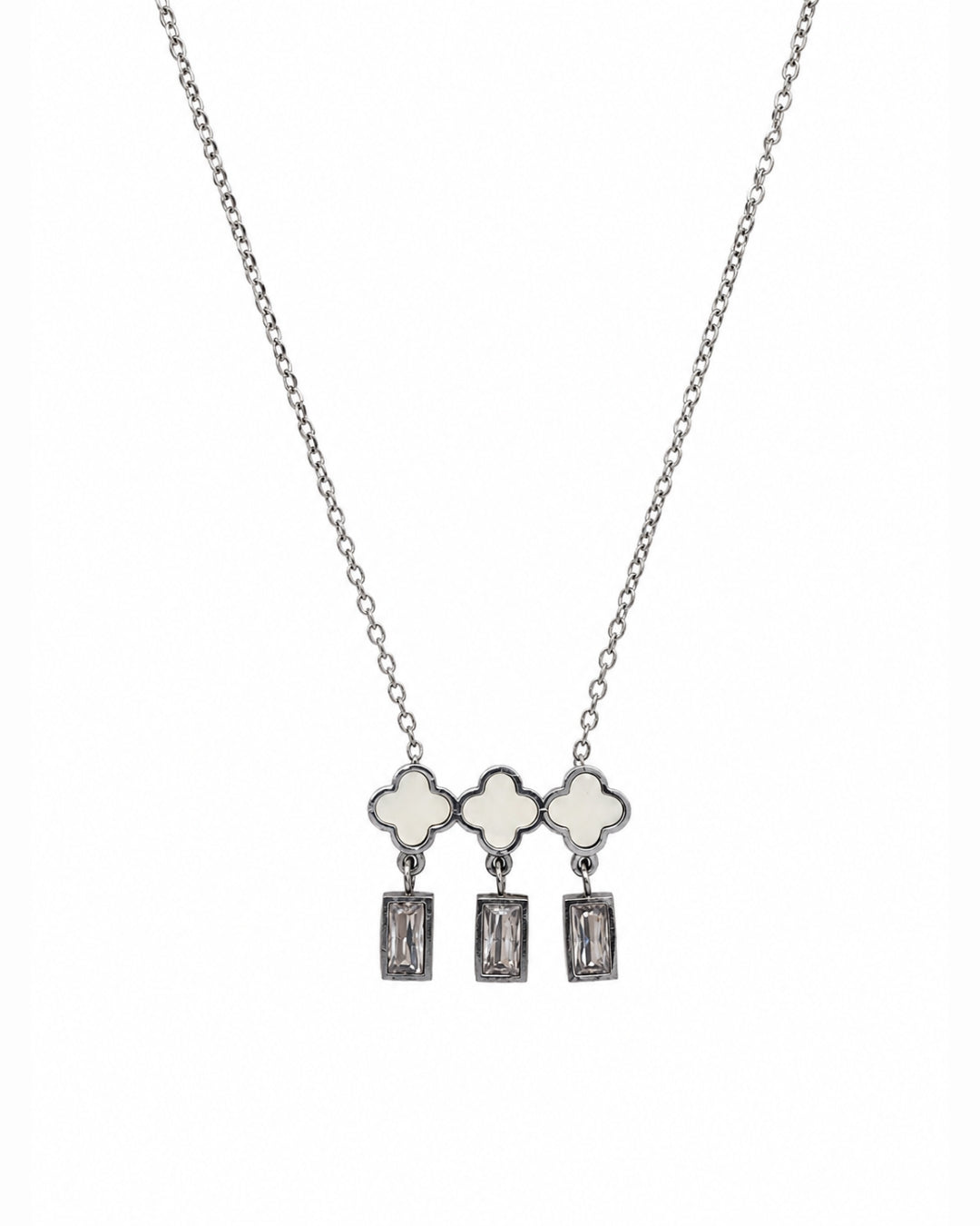 A silver-tone necklace featuring three clover-shaped charms with white inlay, each hanging from a rectangular clear gemstone dangle, shown against a plain white background.