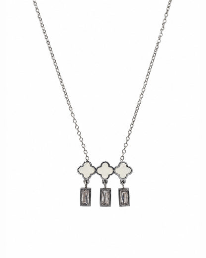 A silver-tone necklace featuring three clover-shaped charms with white inlay, each hanging from a rectangular clear gemstone dangle, shown against a plain white background.