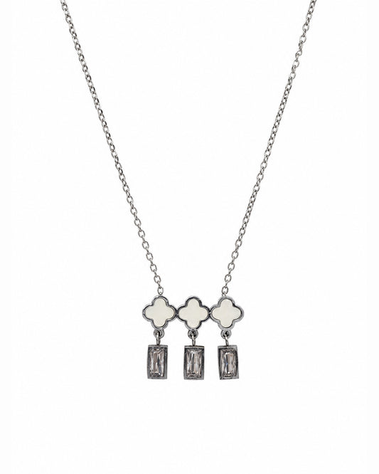A silver-tone necklace featuring three clover-shaped charms with white inlay, each hanging from a rectangular clear gemstone dangle, shown against a plain white background.