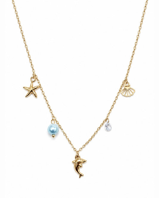A gold chain necklace featuring sea-themed charms, including a starfish, seashell, dolphin, and a light blue pearl bead, shown on a plain white background.