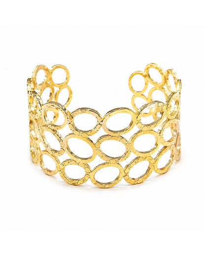 A gold open-link cuff bracelet with a textured, hammered finish, displayed on a clean white background.