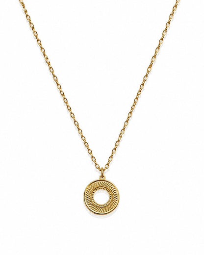 A gold chain necklace with a textured circular pendant featuring a sunburst pattern and a central cutout, displayed on a clean white background.