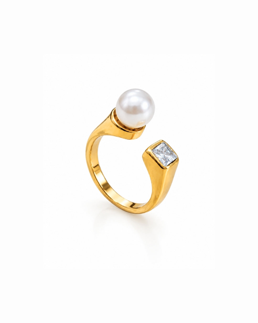 A gold ring featuring a white pearl and a square clear gemstone, set against a plain white background.