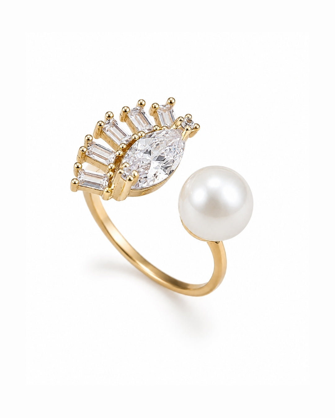 A gold ring featuring a pear-cut clear gemstone surrounded by baguette and round stones, alongside a large white pearl, set against a clean white background.