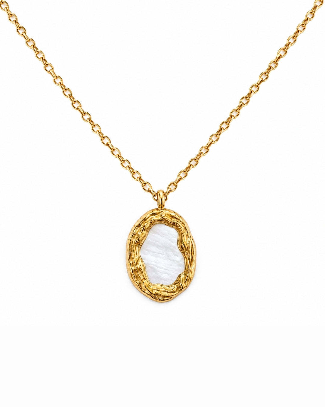 A gold chain necklace with an oval pendant featuring a textured gold border and a smooth, iridescent white inlay, shown on a plain white background.
