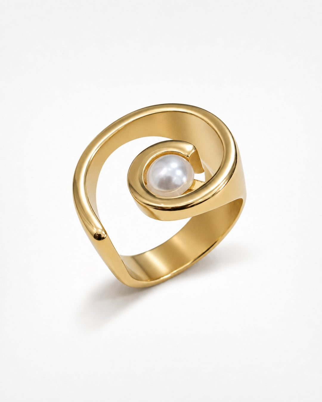 A gold spiral ring with a single white pearl set in the center, photographed on a clean white background.