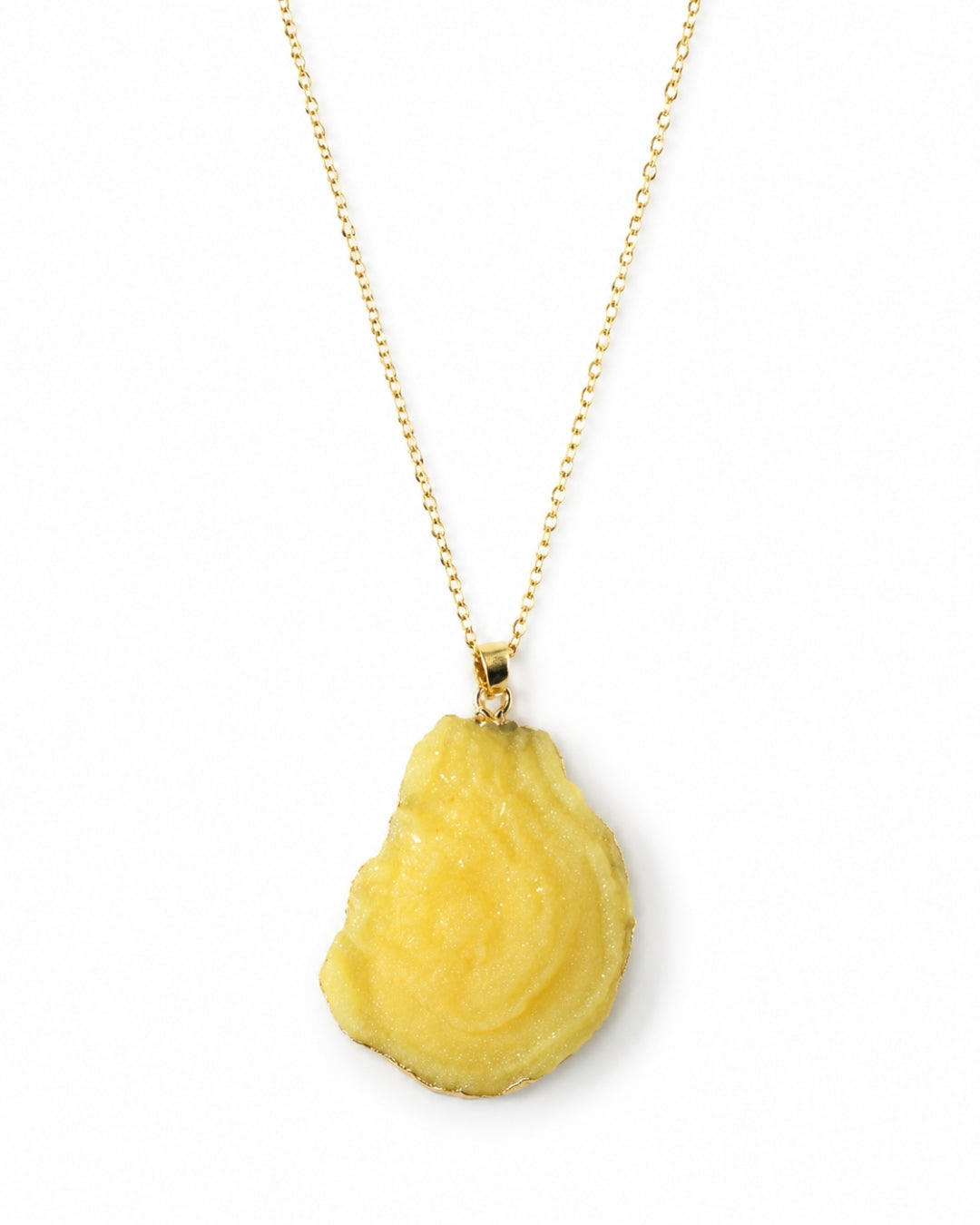 A yellow textured pendant necklace on a delicate gold chain, photographed against a solid white background.