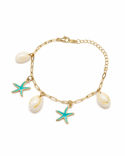 A gold chain bracelet featuring three white cowrie shells and two turquoise starfish charms, displayed on a clean white background.