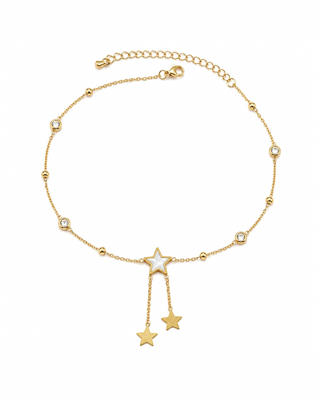 A delicate gold chain anklet featuring a central star charm with a white inlay, flanked by two dangling star charms at the bottom, and small bezel-set clear stones spaced along the chain. The anklet is displayed on a clean white background.