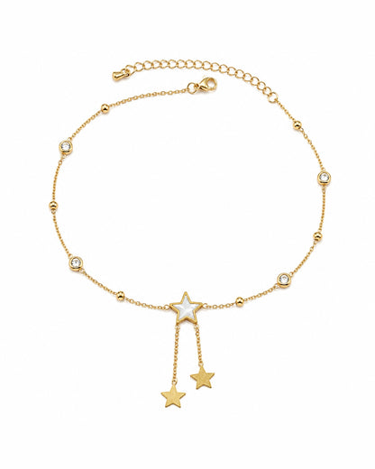 A delicate gold chain anklet featuring a central star charm with a white inlay, flanked by two dangling star charms at the bottom, and small bezel-set clear stones spaced along the chain. The anklet is displayed on a clean white background.