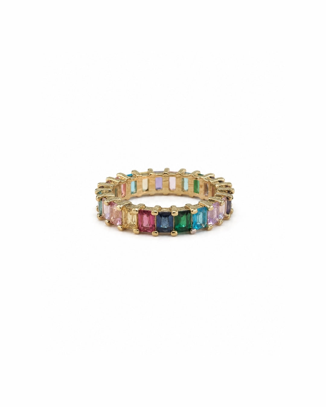 A gold eternity ring featuring a continuous row of colorful rectangular baguette gemstones in shades of pink, red, orange, yellow, green, blue, and purple, set against a plain white background.