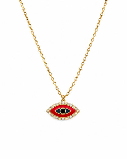 Gold chain necklace with an evil eye pendant featuring a red enamel background, a black pupil, and a border of small clear crystals on a white background.